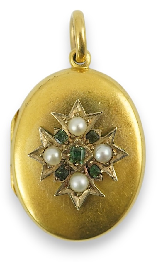 A Victorian gold, split pearl and emerald cluster set oval locket